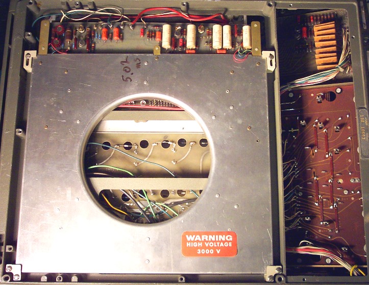 Figure 11 — The delay-line housing in the base of an EC-132, with its "Warning: high voltage 3000 V" label on the CRT shield beside it.