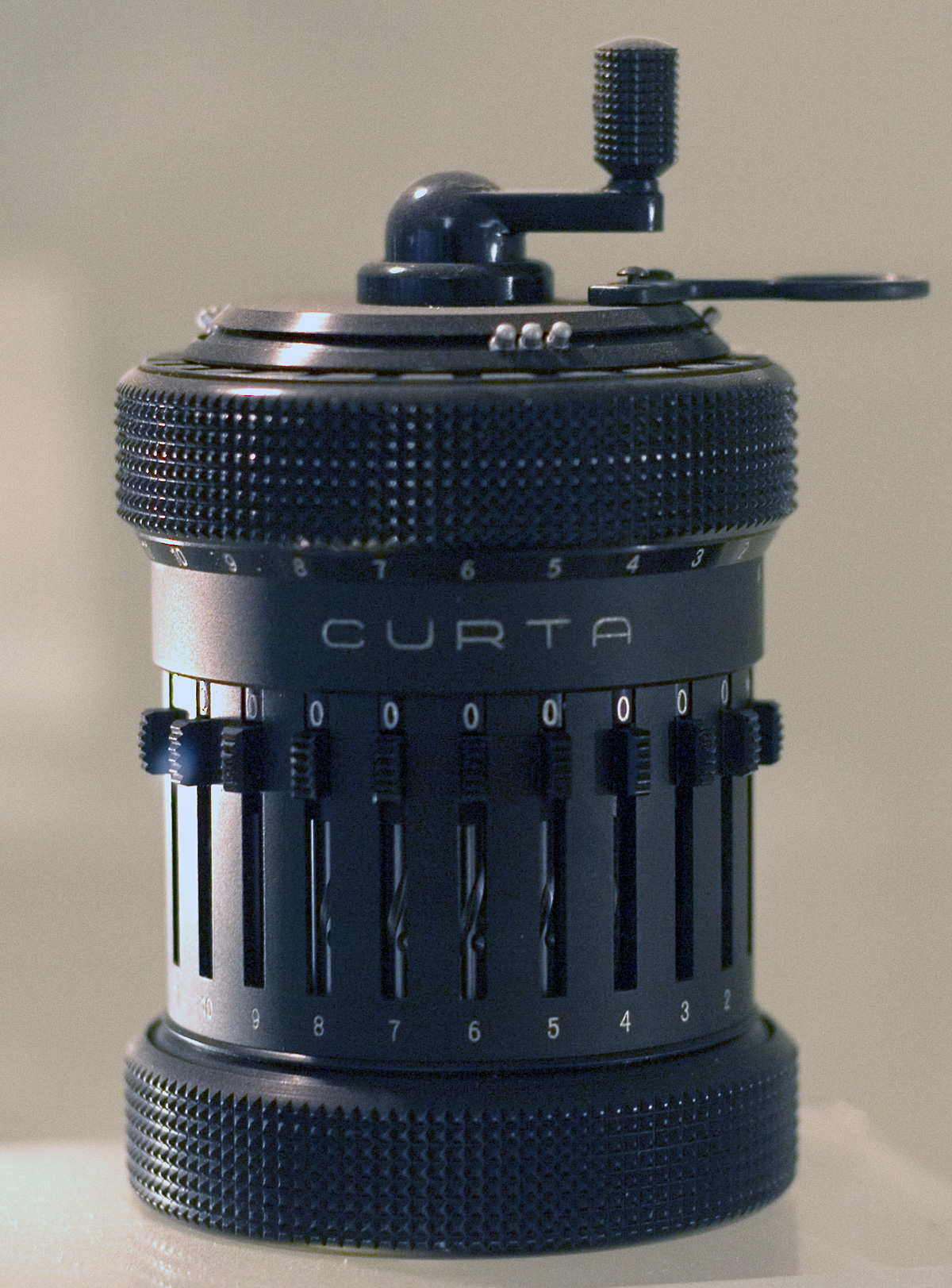 Figure 3 — A Curta Type II on display at the National Museum of Computing, Bletchley Park. Eleven setting slides are visible around the body.