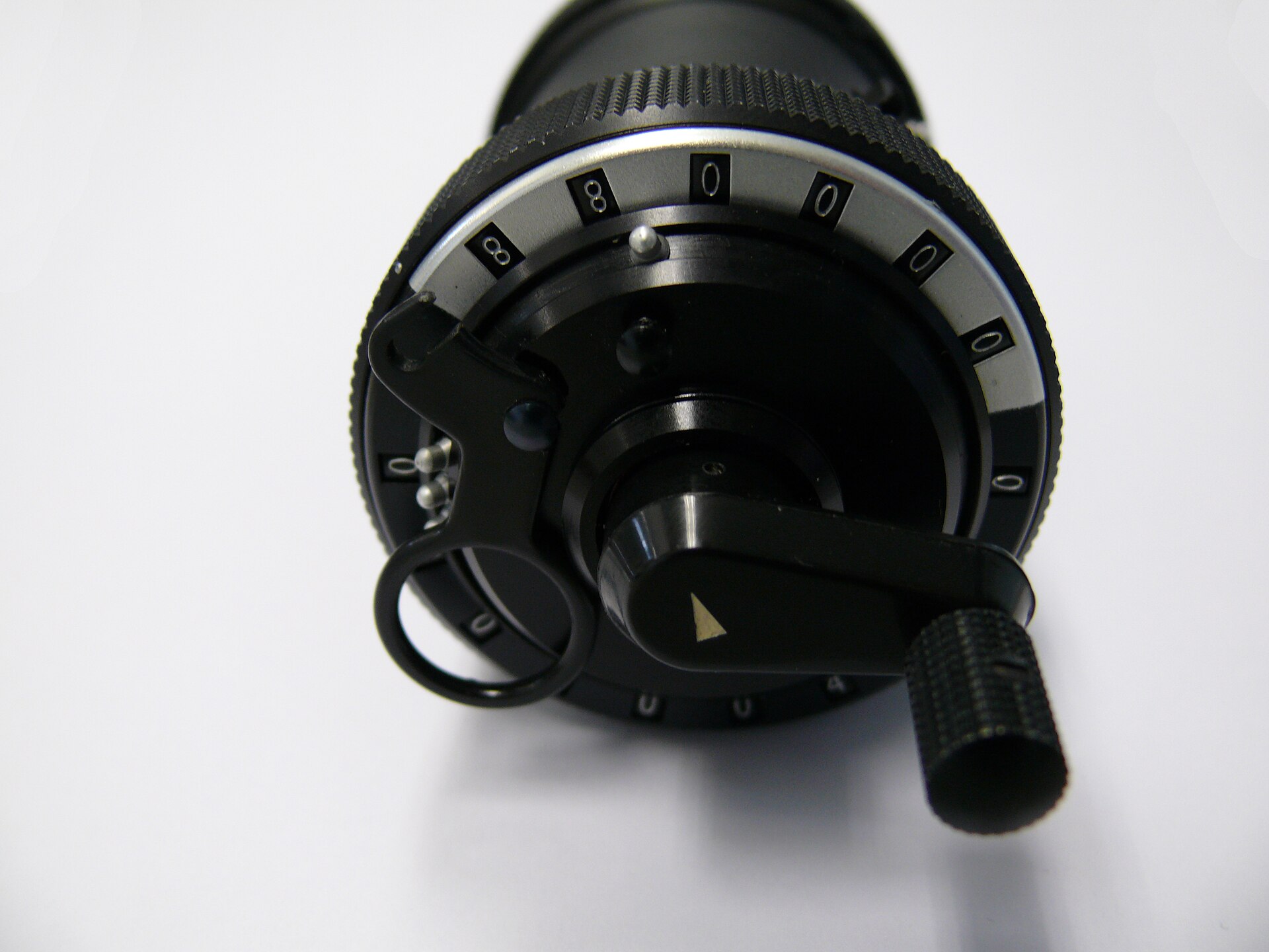 Figure 2 — The top of the machine: the carriage-position scale around the rim, the indicator arrow, the crank, and the clearing lever's travel around the dial ring.