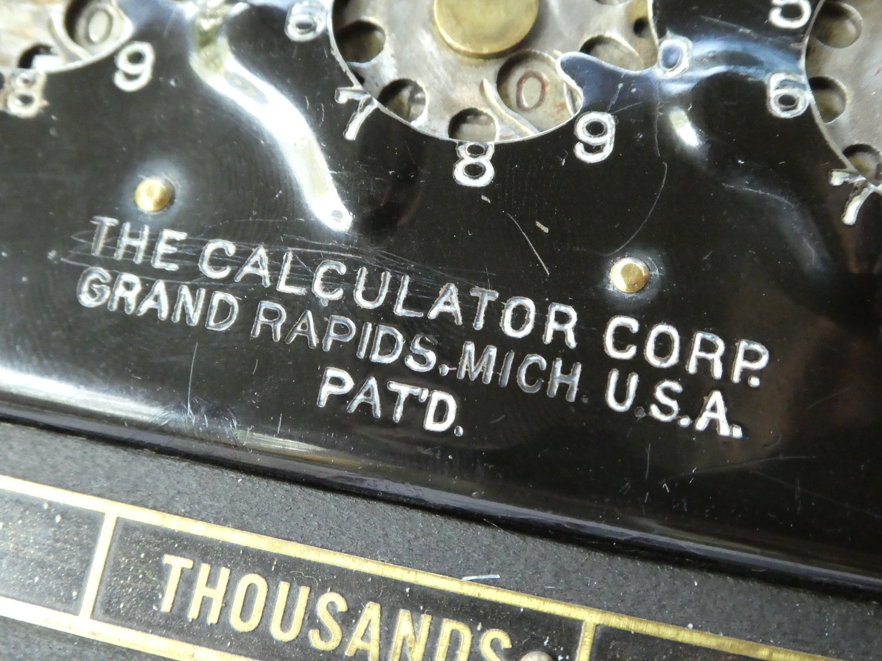 Figure 15 — The Calculator's stamped and paint-filled lettering: "THE CALCULATOR CORP. GRAND RAPIDS, MICH. U.S.A. PAT'D."