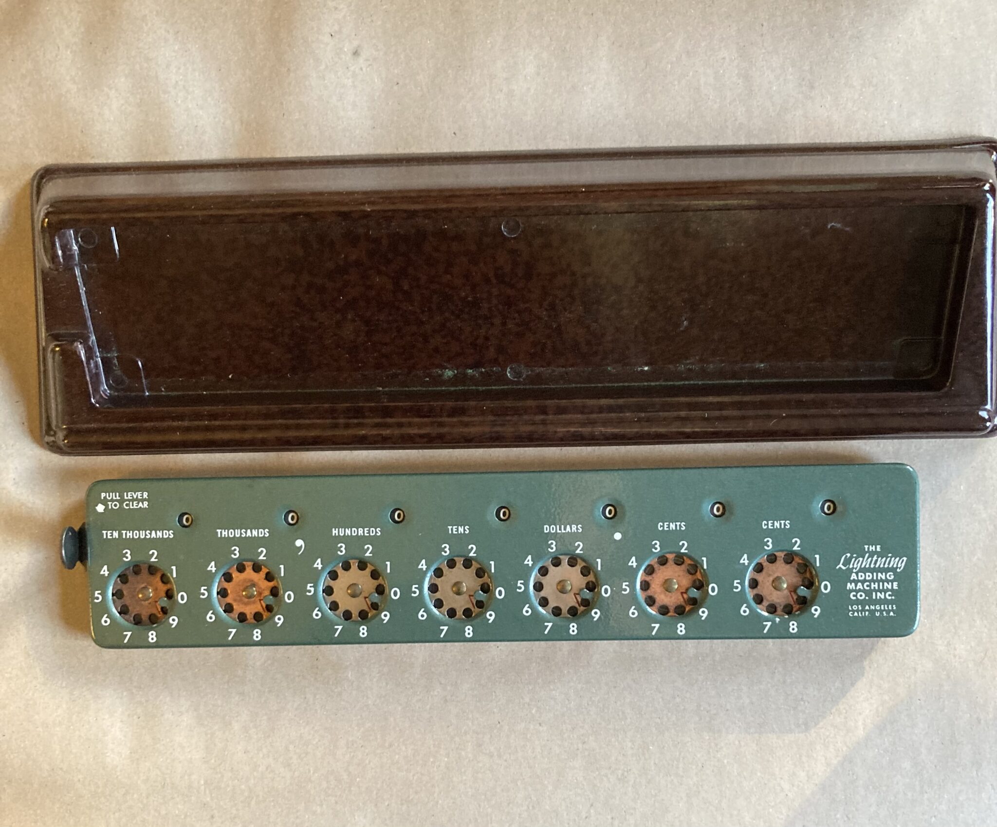 Figure 10 — A green clearing-lever Lightning, "The Lightning Adding Machine Co. Inc.", beside its brown Bakelite stand: the same model as my green machine.