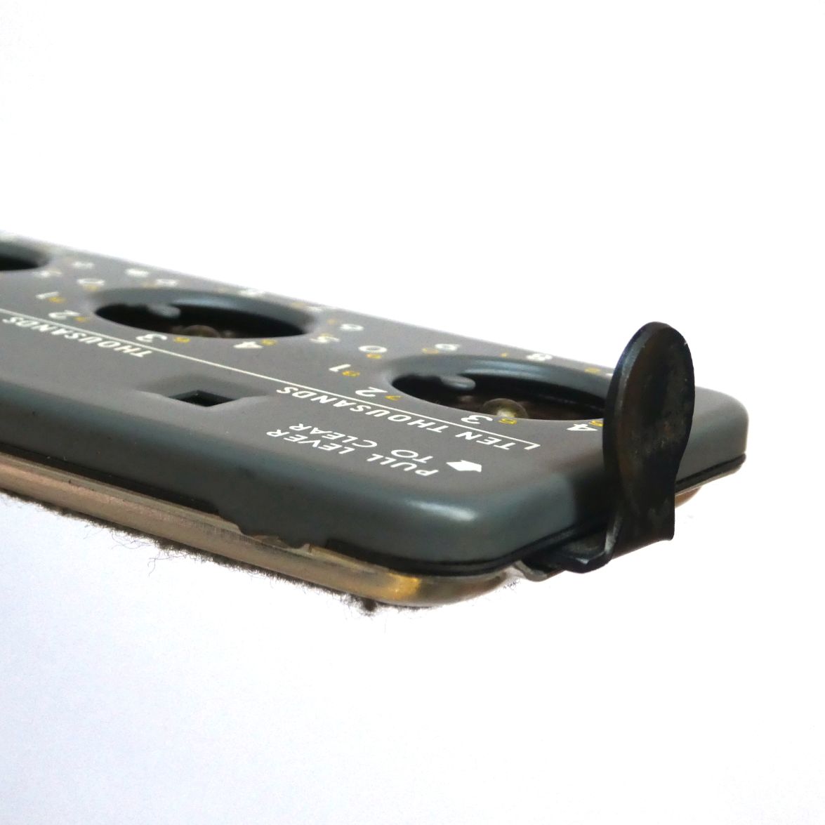 Figure 7 — The clearing tab at rest, seen end-on, projecting from the left end of the body.