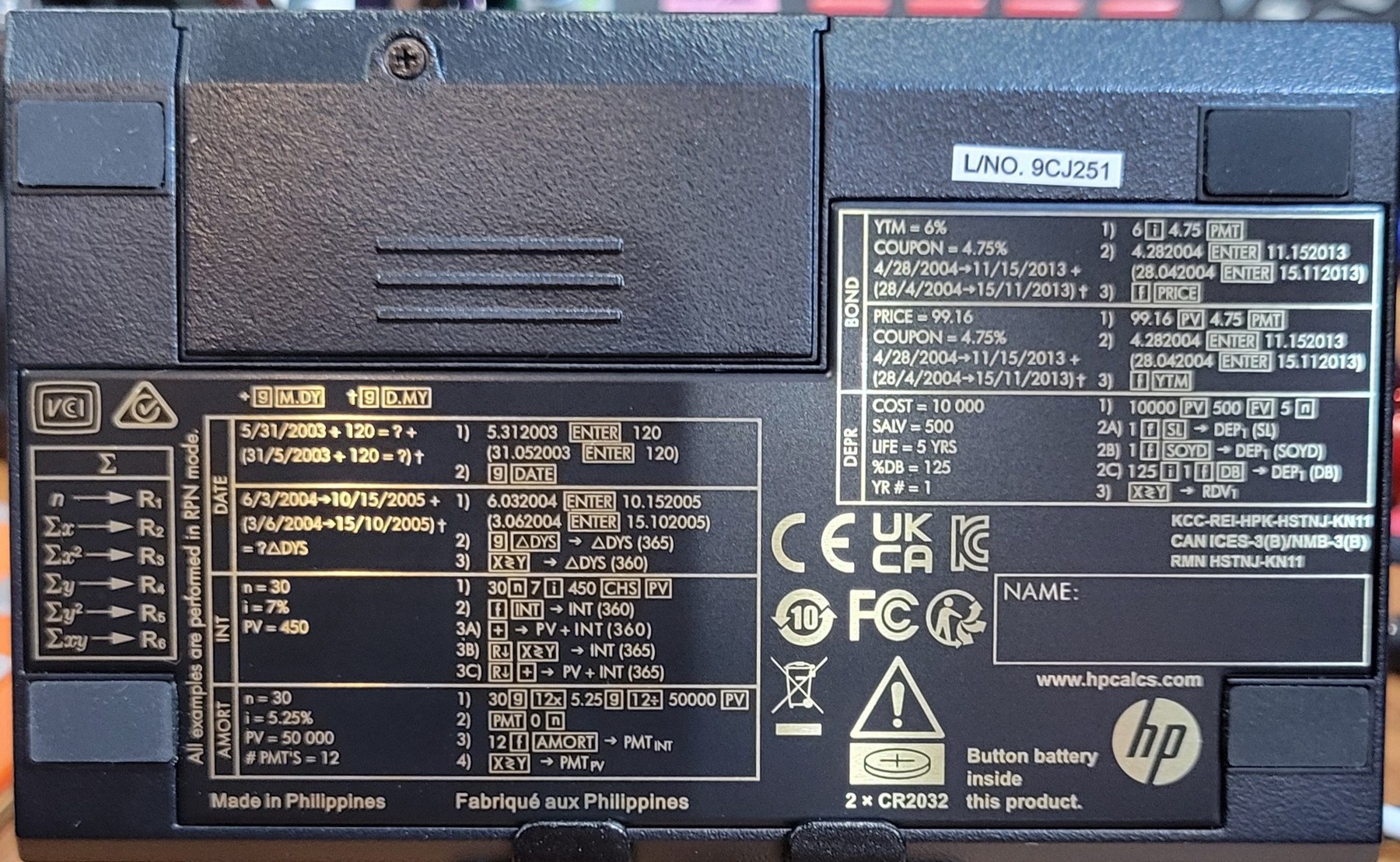 Figure 2 — The back of my 12C: the battery door with its screw, the lot number 9CJ251, and HP's worked examples for dates, interest, amortization, bonds and depreciation.