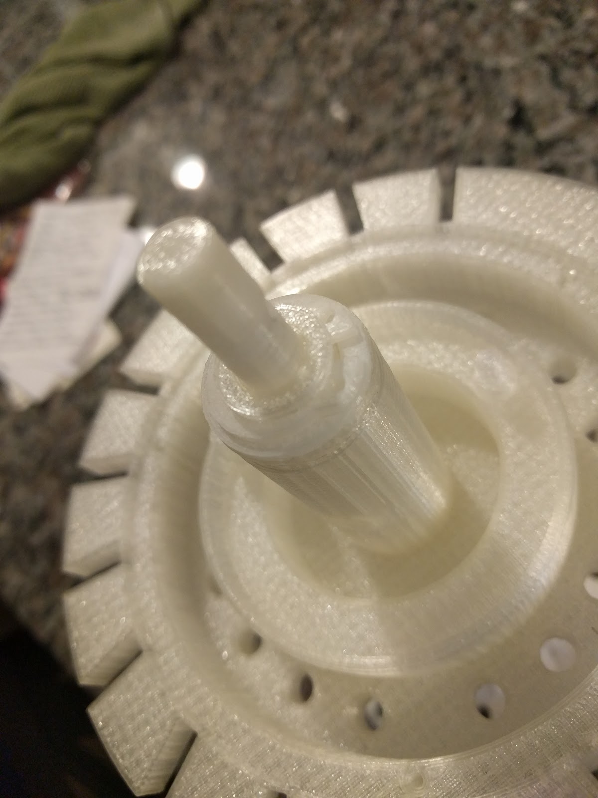 Figure 9 — The main shaft through the bearing plate. The shaft fractured at the crank pin hole when the mechanism seized and was forced; it was reprinted at 100% infill.