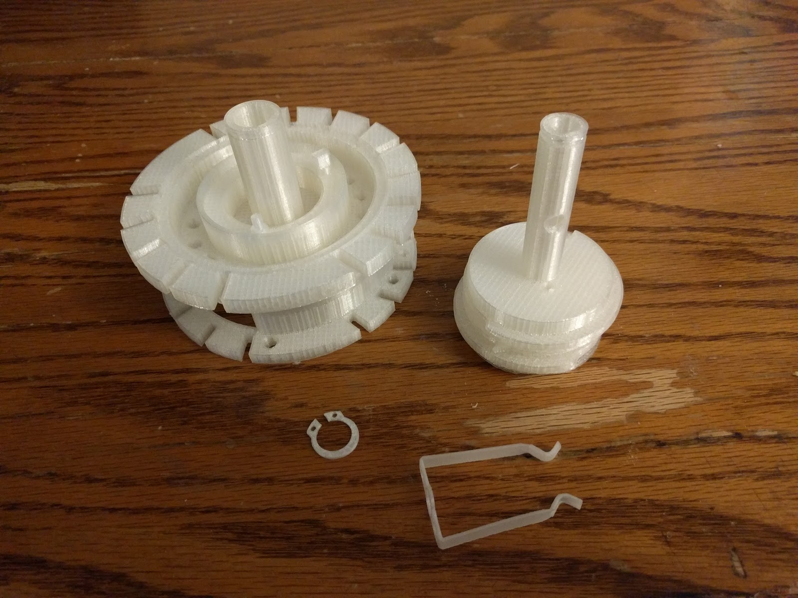 Figure 12 — Printed sub-assemblies with a C-clip and hand-wound springs — the mix of printed and non-printed parts that the machine actually is.