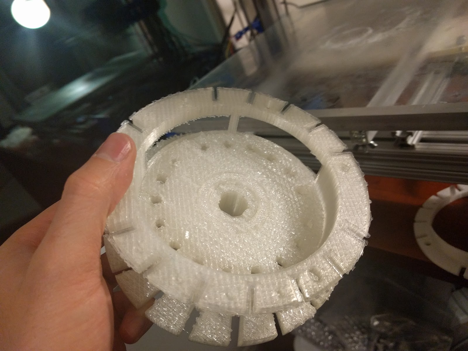 Figure 2 — The printed tens bell in hand. The ramped reset section that returns the carry levers runs around its rim.