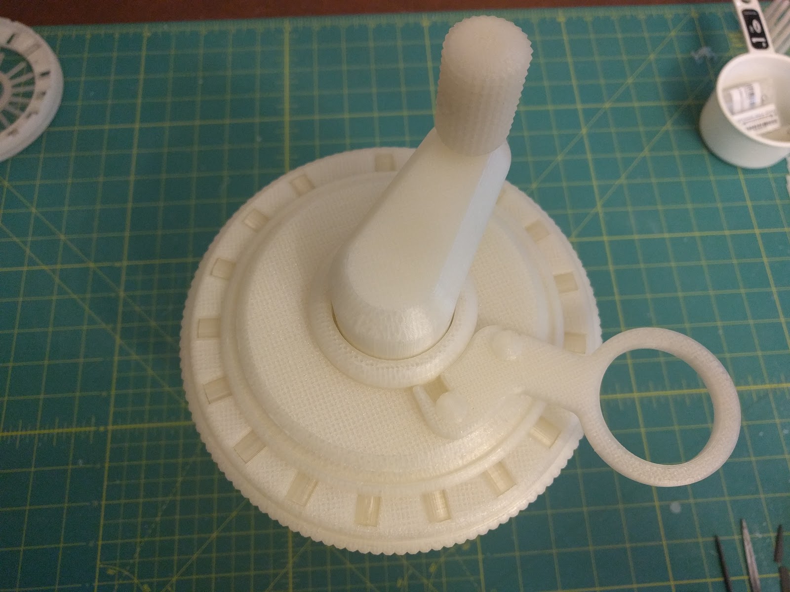 Figure 7 — The crank and the clearing ring. The clearing action is the sub-mechanism that gave the most trouble at printed scale — it is stiff, and it does not always return every wheel to zero.