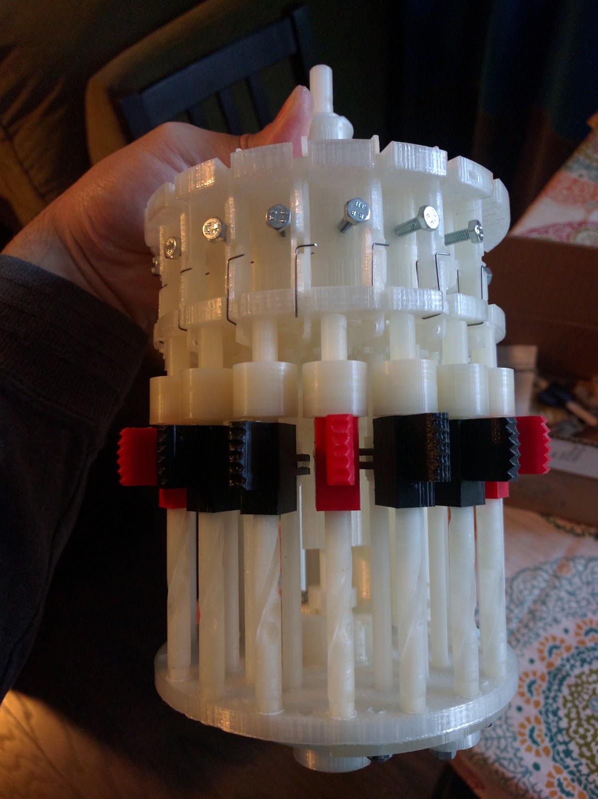 Figure 6 — The setting slides in place, with their red and black markers. On the original these are eight small metal knobs in narrow slots; printed at 3:1 they become the machine's most legible feature.