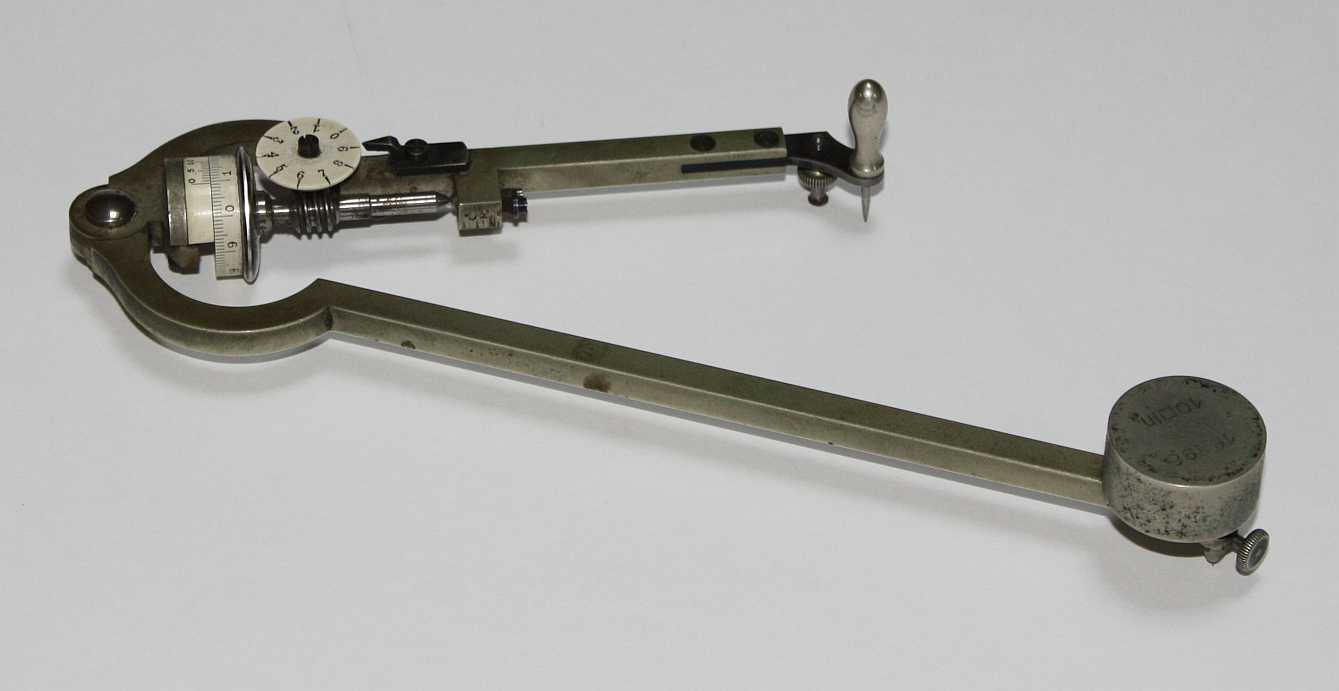 Figure 4 — An Amsler polar planimeter: the classic fixed-arm instrument, with the pole weight at the end of its arm and the wheel and dial on the tracer arm.