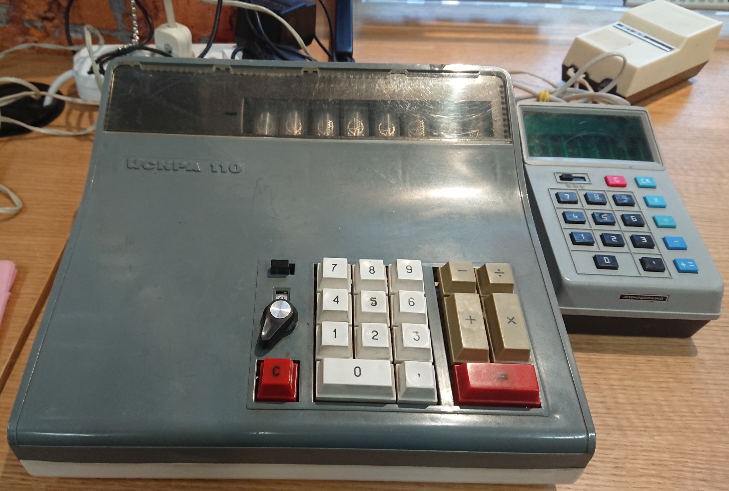 Figure 11 — An Iskra 110 of 1971, one of the first Soviet calculators on integrated circuits, beside a later Elektronika B3-08, in the Yandex museum.