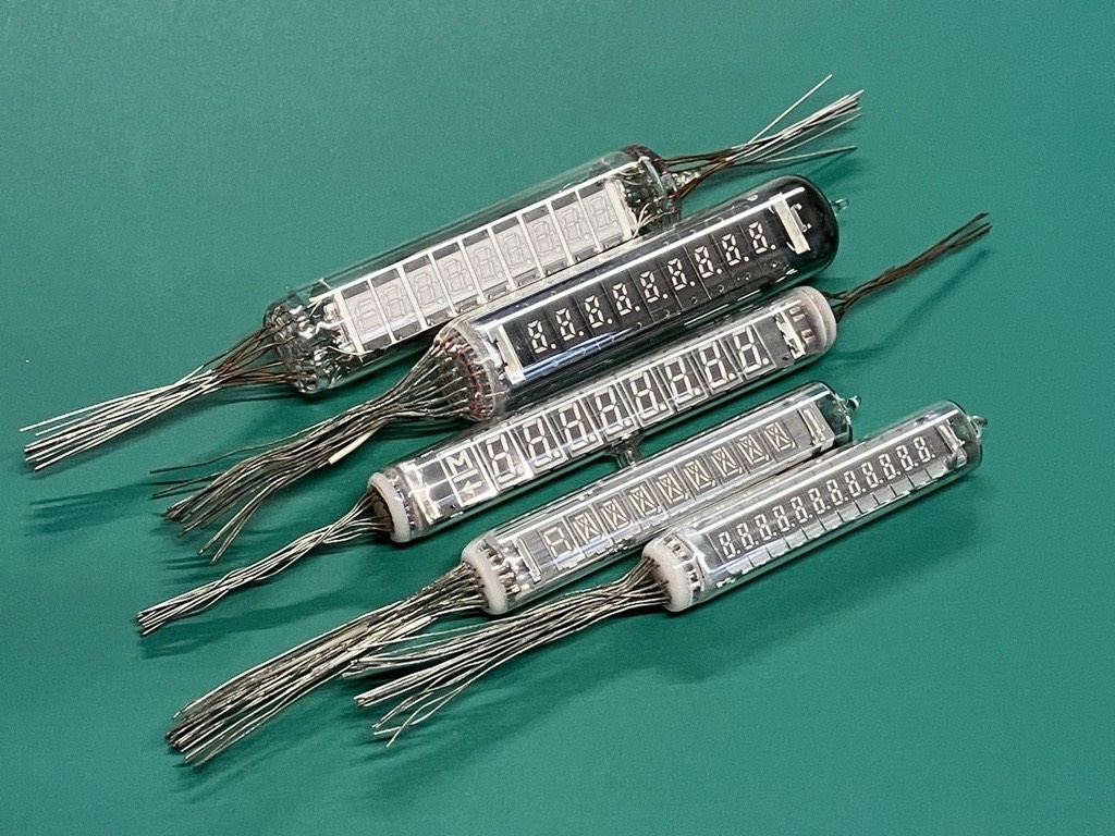 Figure 7 — Round multi-digit tubes of the early 1970s: several digits in one glass envelope, each with its own grid, the leads brought out at the ends.
