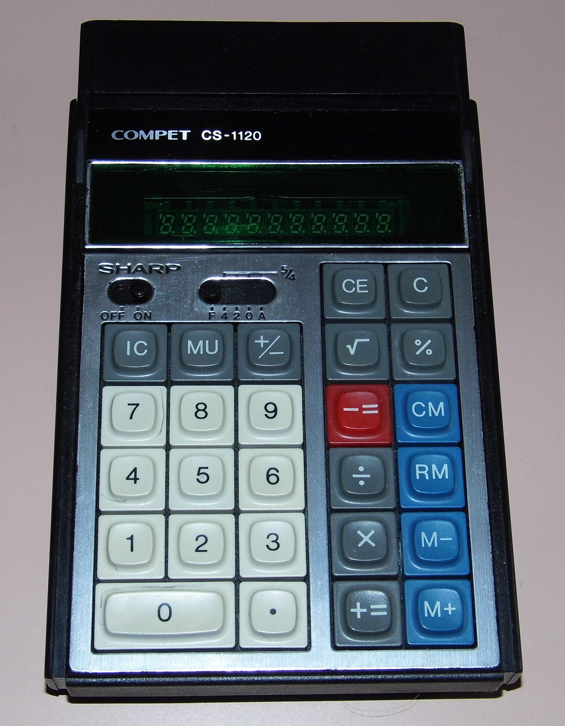 Figure 6 — A Sharp Compet CS-1120 of about 1975, a small desk machine with a green multi-digit tube and a flip-up stand.