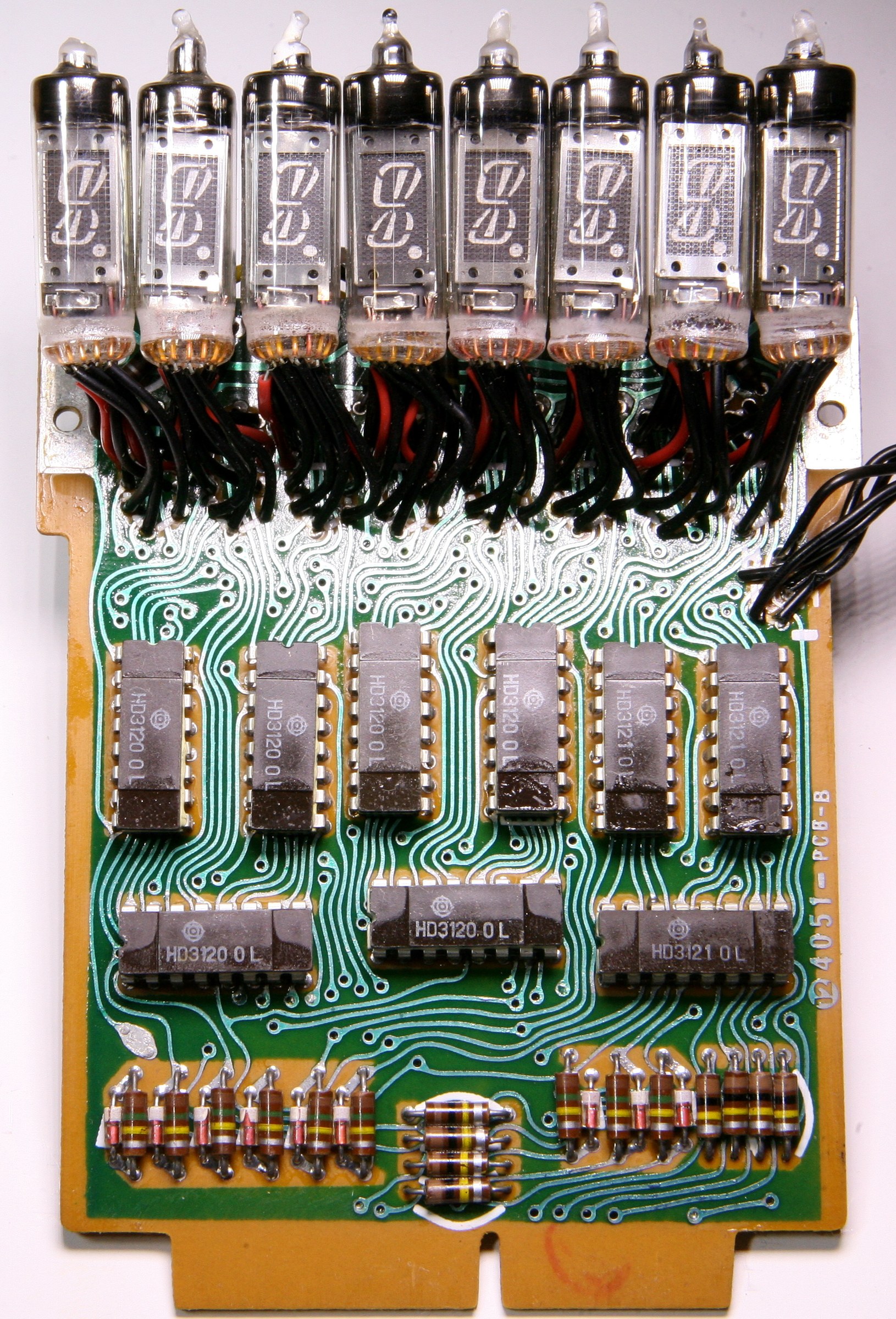 Figure 9 — The display and main circuit boards of a Sharp EL-8: eight Itron tubes on their flying leads above a row of Hitachi driver packages, the stage between the Rockwell chips and the tubes.