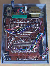 Figure 9 — Inside the Crown CL-80K of 1972: a small mains transformer, one TI TMS0105 chip and the discrete transistors that drive the fluorescent tubes.