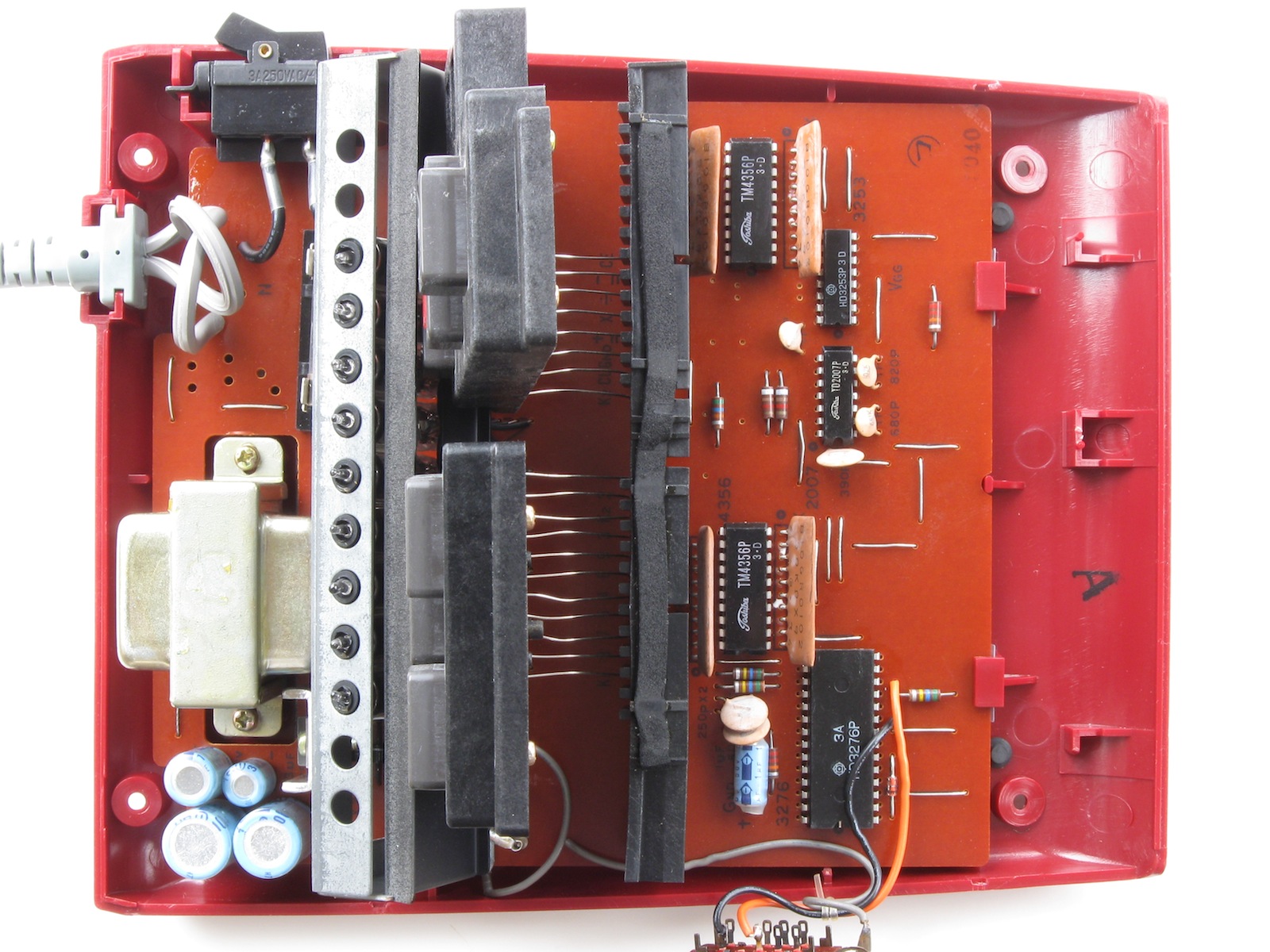 Figure 4 — Inside a Sharp ELSI-804 desk calculator: the mains transformer, the single-digit tubes and the circuit board with its Hitachi chips.
